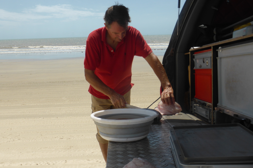 Filleting fish on the beach